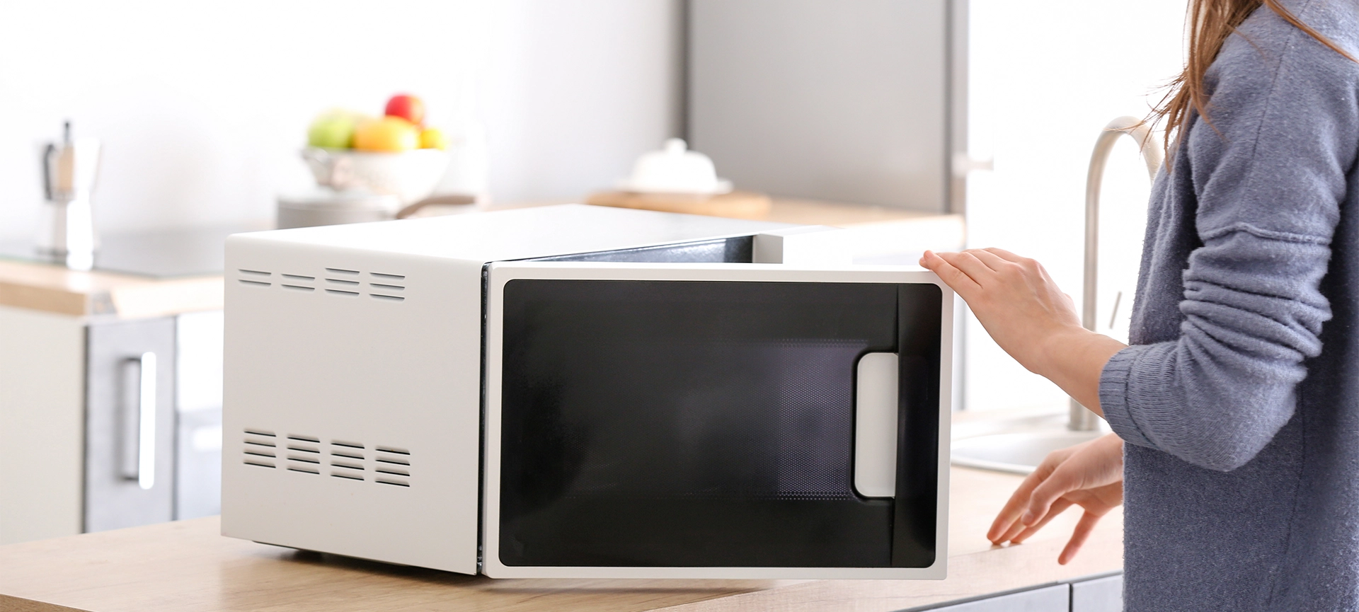 girl opening microwave door